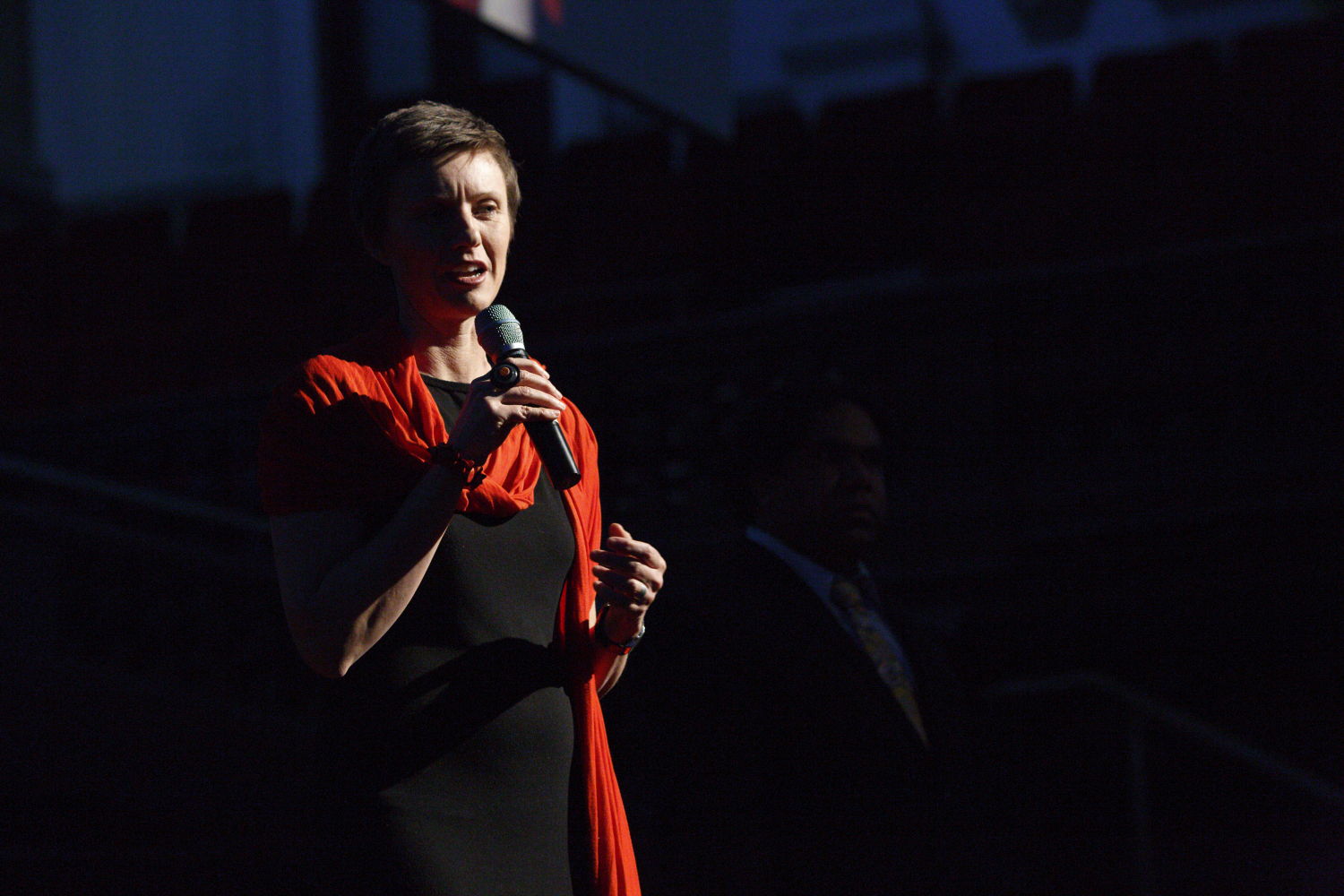 Rebecca Scott, co-founder and CEO of STREAT, standing on stage in a red top holding a microphone